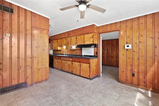 4365 US Highway 341, Jesup, GA 31545 - kitchen with under cabinet range hood, wood walls, ornamental molding, dark countertops, and brown cabinets