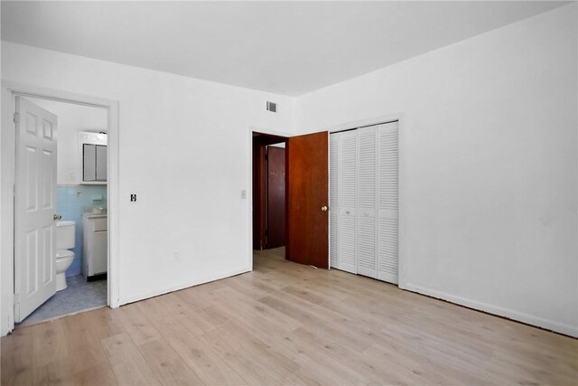 4365 US Highway 341, Jesup, GA 31545 - unfurnished bedroom with light wood-style floors, a closet, and connected bathroom
