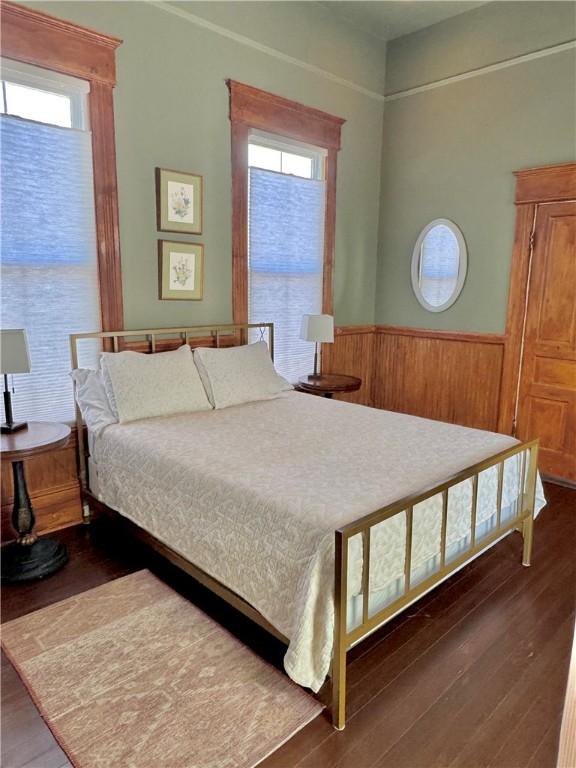 1915 Union St, Brunswick, GA 31520 - bedroom featuring wainscoting, wood finished floors, and wooden walls