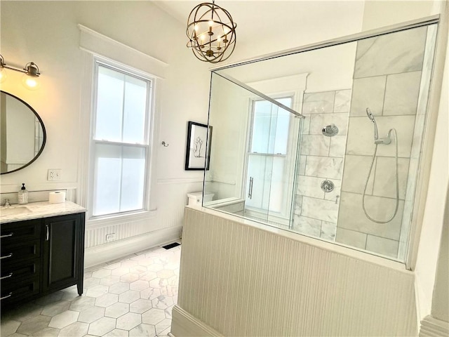 1915 Union St, Brunswick, GA 31520 - bathroom featuring a tile shower, vanity, tile patterned flooring, and a chandelier