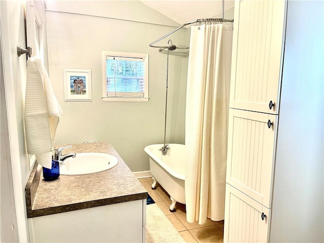 1915 Union St, Brunswick, GA 31520 - full bathroom with a tub, tile patterned flooring, a shower with curtain, vanity, and vaulted ceiling