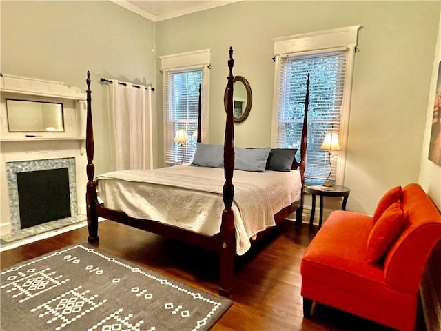 1915 Union St, Brunswick, GA 31520 - bedroom featuring wood finished floors, crown molding, and a fireplace with raised hearth
