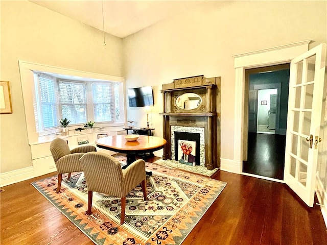1915 Union St, Brunswick, GA 31520 - living area featuring a fireplace with flush hearth, wood finished floors, baseboards, and a towering ceiling