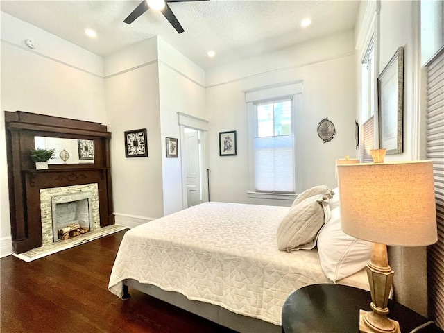 1915 Union St, Brunswick, GA 31520 - bedroom with wood finished floors, baseboards, ceiling fan, recessed lighting, and a fireplace with flush hearth