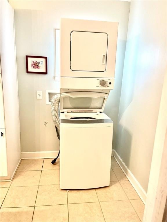 1915 Union St, Brunswick, GA 31520 - laundry room with estacked washer and dryer, light tile patterned floors, and baseboards