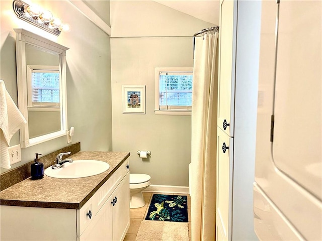 1915 Union St, Brunswick, GA 31520 - full bathroom with tile patterned flooring, toilet, vanity, baseboards, and a shower with shower curtain
