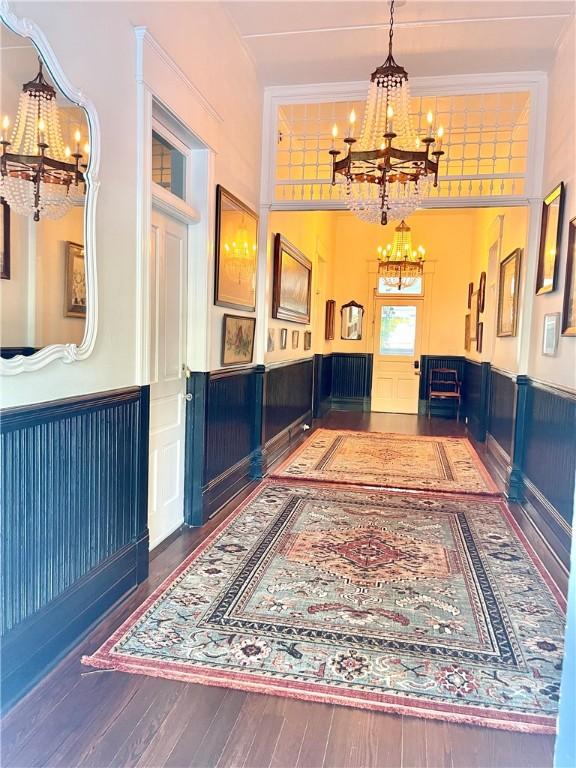 1915 Union St, Brunswick, GA 31520 - entryway with a chandelier, a wainscoted wall, and wood-type flooring