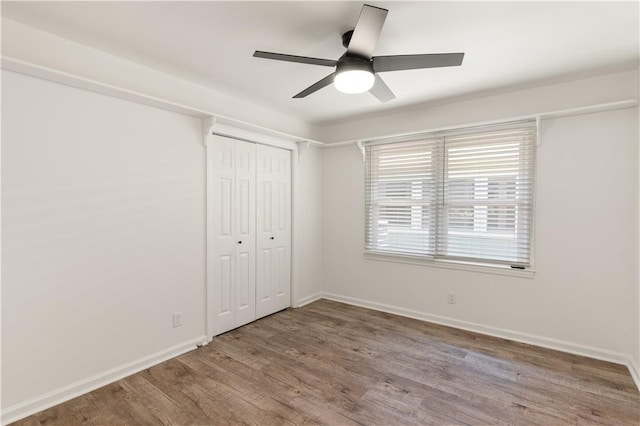 3120 Willow Ave, Brunswick, GA 31520 - unfurnished bedroom with wood finished floors, baseboards, a closet, and a ceiling fan