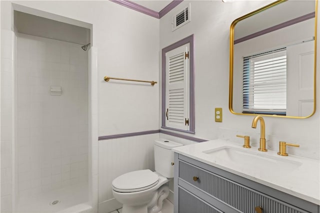 3120 Willow Ave, Brunswick, GA 31520 - bathroom with toilet, tiled shower, wainscoting, and vanity