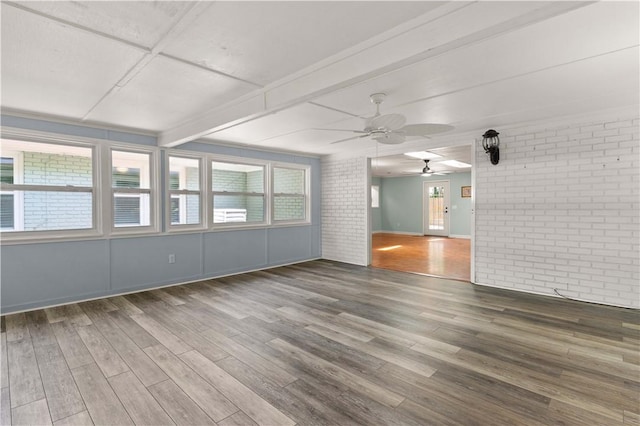 3120 Willow Ave, Brunswick, GA 31520 - empty room with brick wall, a ceiling fan, wood finished floors, and beamed ceiling