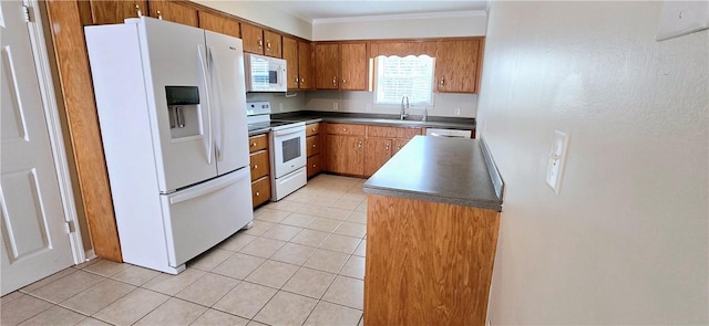 146 Don El St, Brunswick, GA 31523 - kitchen featuring white appliances, ornamental molding, brown cabinetry, dark countertops, and light tile patterned flooring