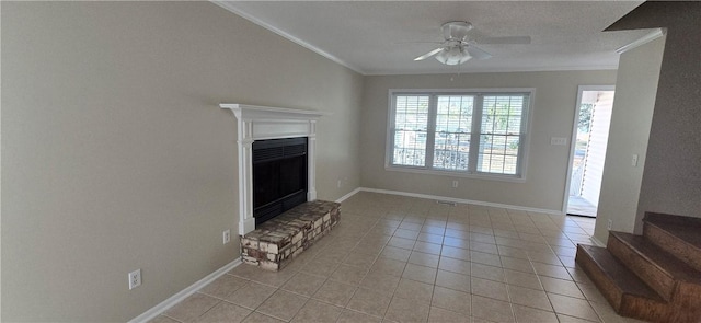 146 Don El St, Brunswick, GA 31523 - unfurnished living room featuring crown molding, ceiling fan, light tile patterned flooring, a fireplace with raised hearth, and stairs