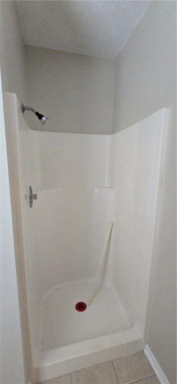 146 Don El St, Brunswick, GA 31523 - bathroom featuring a stall shower, tile patterned floors, and a textured ceiling