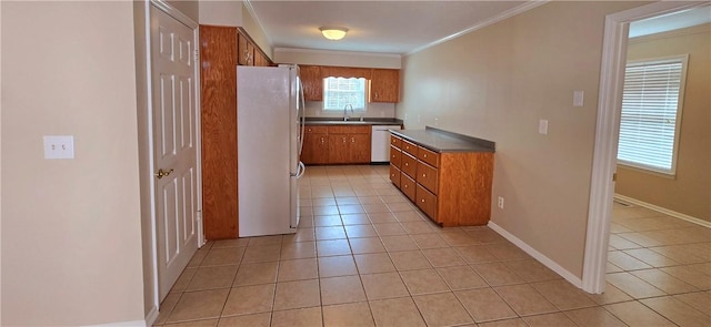 146 Don El St, Brunswick, GA 31523 - kitchen featuring freestanding refrigerator, dishwasher, brown cabinetry, light tile patterned floors, and crown molding