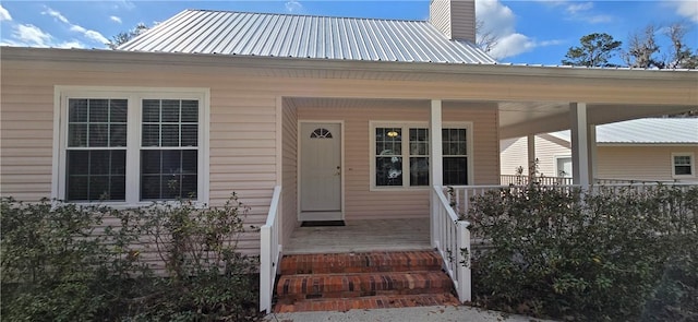 146 Don El St, Brunswick, GA 31523 - doorway to property with a porch, a metal roof, and a chimney