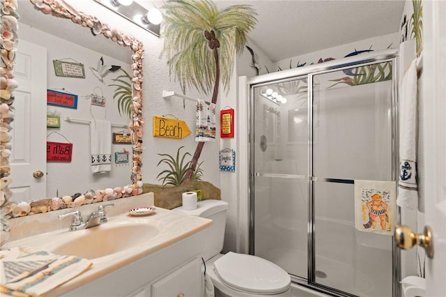 full bathroom with a stall shower, vanity, and toilet