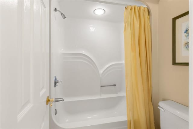 bathroom with toilet and shower / bathtub combination with curtain