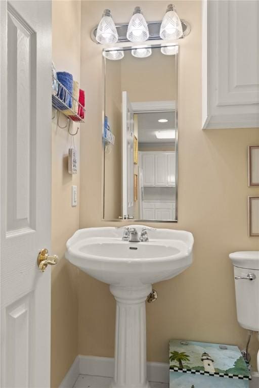 half bath featuring baseboards