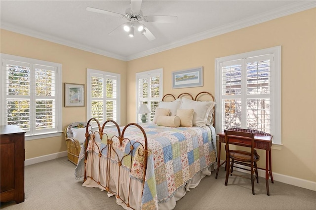 carpeted bedroom with baseboards, ornamental molding, and a ceiling fan