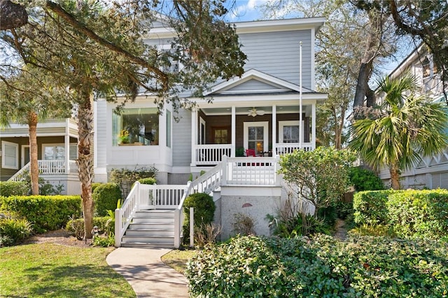 view of front of property with a porch, ceiling fan, and stairway