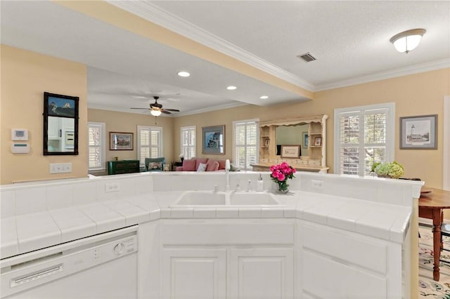 kitchen with tile countertops, a sink, open floor plan, and dishwasher