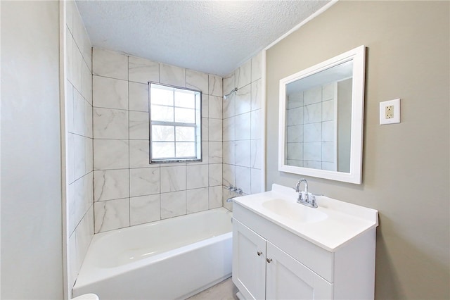 bathroom featuring tub / shower combination, a textured ceiling, and vanity