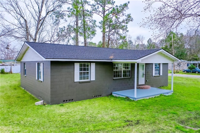 exterior space featuring crawl space, concrete block siding, a front lawn, and roof with shingles