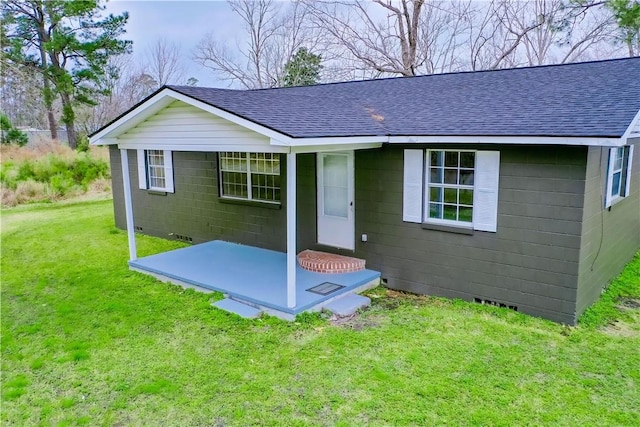 exterior space featuring a shingled roof, crawl space, and a front yard