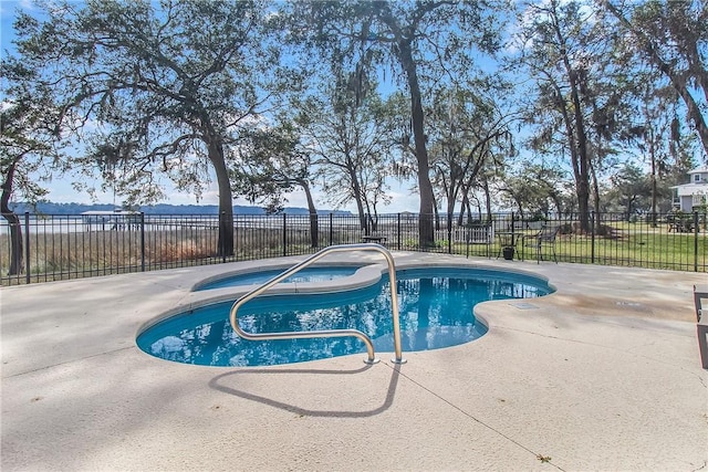 view of pool with a patio area, a fenced in pool, an in ground hot tub, and fence