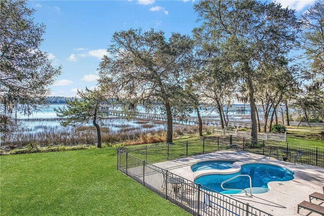 view of pool featuring a yard, a patio, an in ground hot tub, and fence