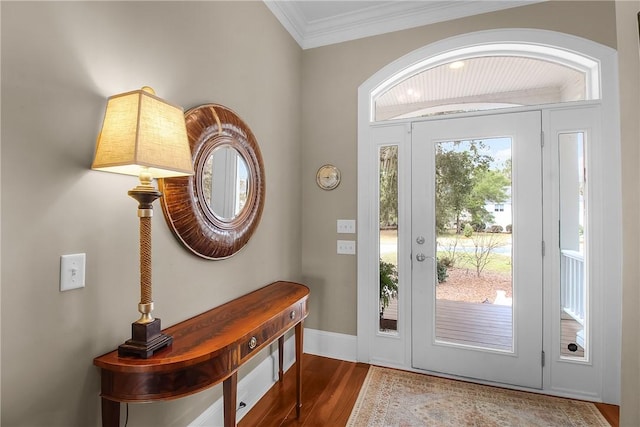 foyer entrance with wood finished floors, baseboards, and ornamental molding