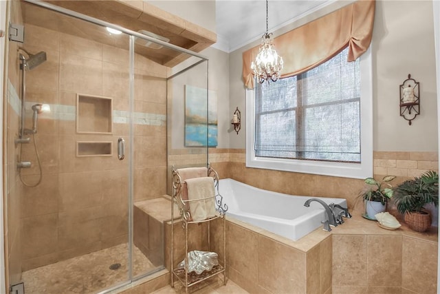 bathroom featuring a notable chandelier, a bath, a shower stall, and crown molding