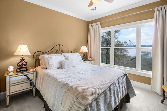 bedroom with visible vents, carpet floors, crown molding, baseboards, and ceiling fan