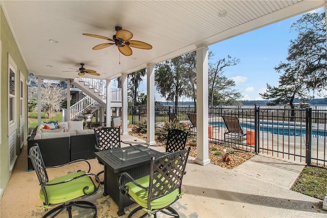 view of patio / terrace featuring a ceiling fan, fence, stairway, a fenced in pool, and an outdoor hangout area