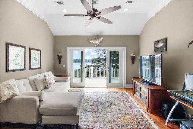 living room with lofted ceiling, light wood-style flooring, visible vents, and ceiling fan