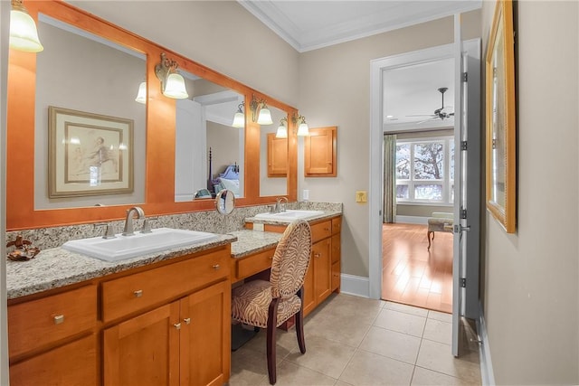 full bathroom with a sink, double vanity, crown molding, and tile patterned floors