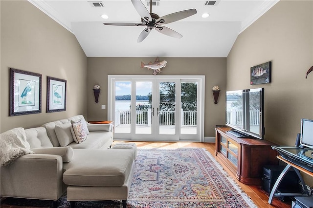 living area featuring visible vents, french doors, light wood-style floors, and lofted ceiling