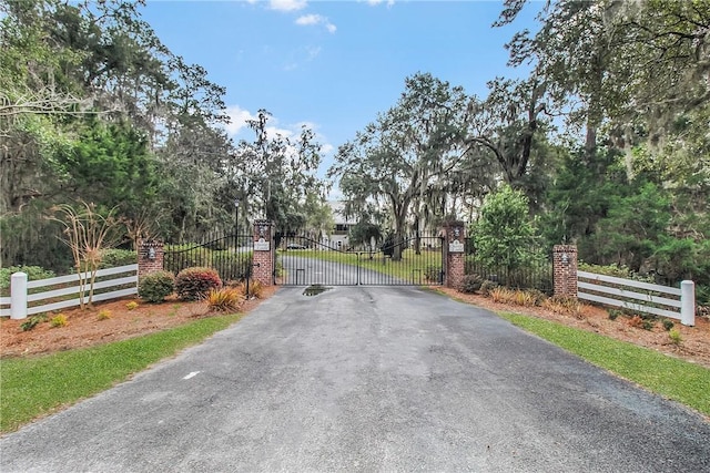 view of street with a gate and a gated entry