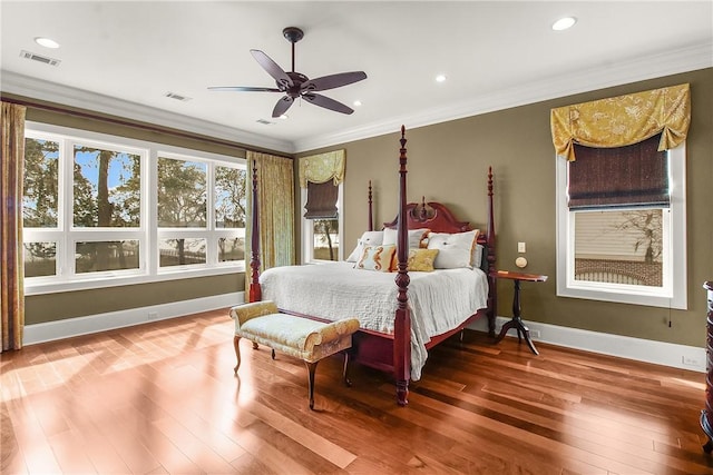 bedroom with visible vents, hardwood / wood-style flooring, and ornamental molding