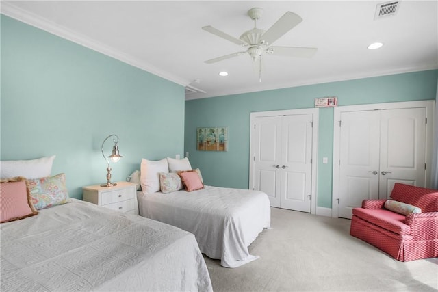 bedroom with visible vents, recessed lighting, multiple closets, crown molding, and light colored carpet