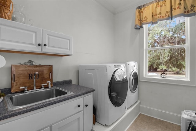 laundry area with washer and clothes dryer, ornamental molding, light tile patterned floors, cabinet space, and a sink