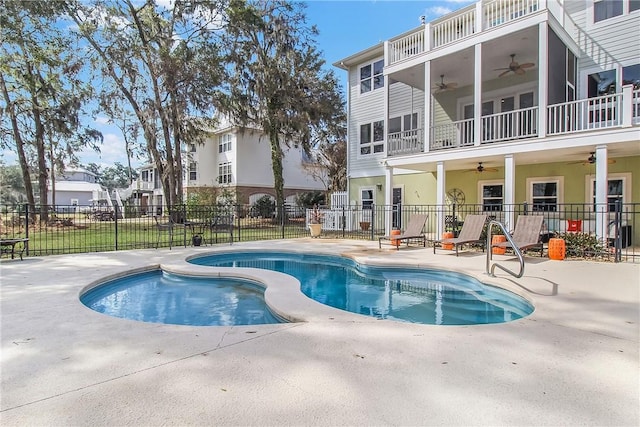 view of swimming pool featuring a patio area, fence, a fenced in pool, and ceiling fan