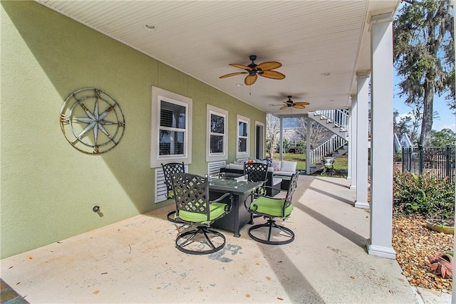 view of patio / terrace featuring stairway, outdoor dining area, a ceiling fan, and fence