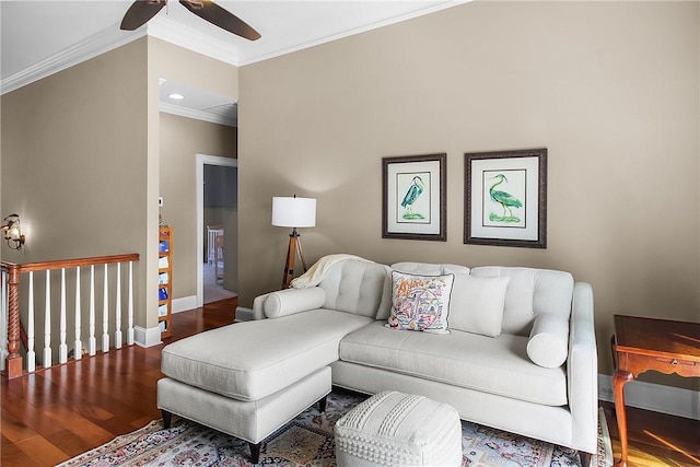 living area featuring ceiling fan, crown molding, baseboards, and wood finished floors