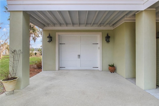 garage featuring concrete driveway