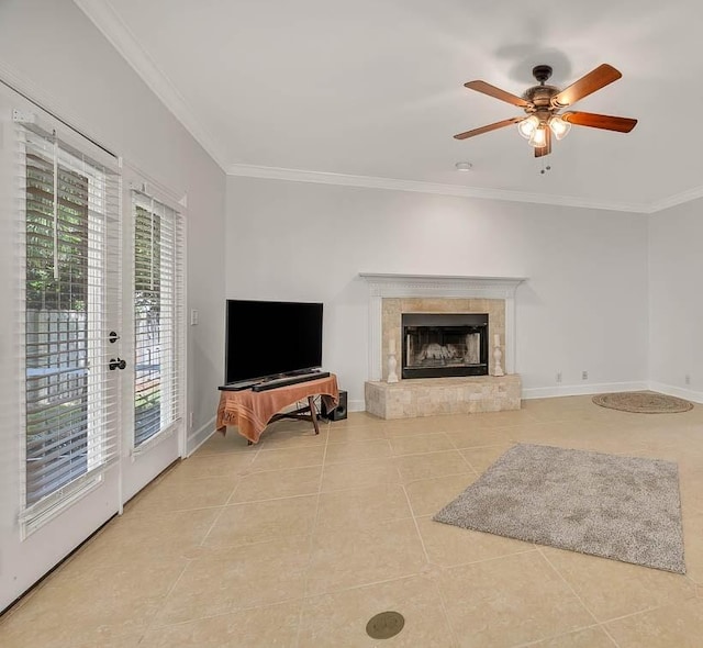 tiled living room featuring ceiling fan, a fireplace, and crown molding