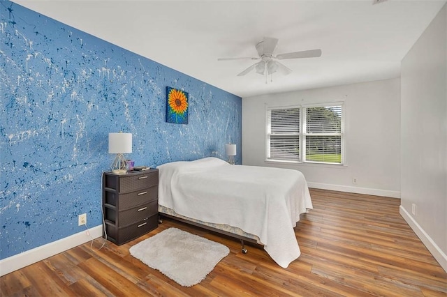 bedroom featuring hardwood / wood-style floors and ceiling fan