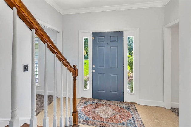 entryway with a wealth of natural light and ornamental molding