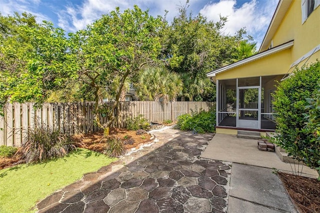 view of patio with a sunroom