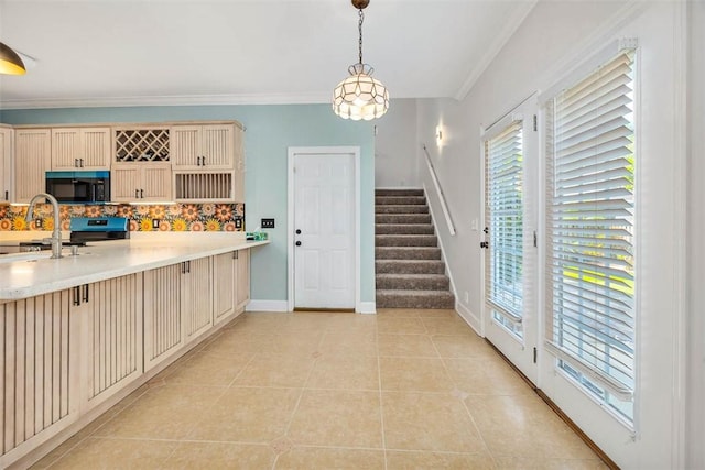 kitchen with light tile patterned floors, backsplash, hanging light fixtures, and black appliances